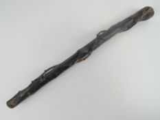 An Irish black painted natural wood knobkery. 58cm in length.