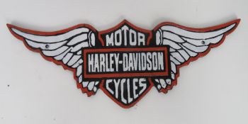 A contemporary cast metal Harley Davidson sign.