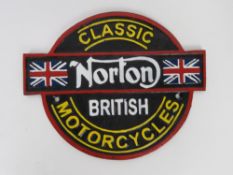 A contemporary cast metal Norton sign.
