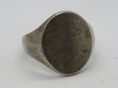 A large HM silver mens signet ring, uncarved oval central panel, hallmarked for Birmingham, size V.