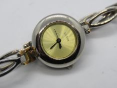 A Guess wristwatch having champagne dial with two tone bracelet strap.