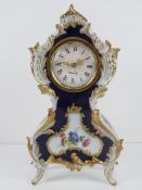 A German made ceramic mantle clock in cobalt blue and white ground with gilded and foliate