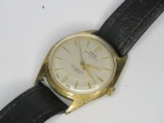 A vintage Oris wristwatch, gold plated with silvered dial, on black leather strap.