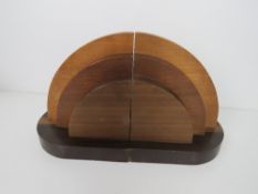 A pair of Art Deco bookends in tri colour wood, 15cm high.