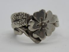 A silver floral design ring, stamped 925, size O.