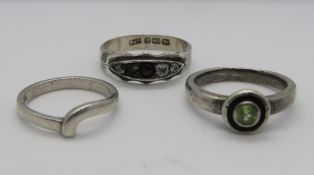 Three silver rings; one hallmarked silver set with five stones, size Q,