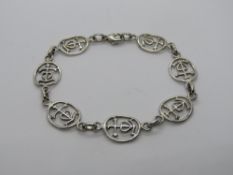A silver bangle having anchor and heart design, stamped 925.