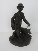 A heredites bronzed figurine of a shepherd and dog.