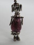 An articulated silver pendant in the form of a girl having glass bead body, stamped 925, 45mm.