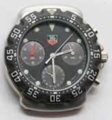 A Tag Heuer watch head, stainless steel with black plastic bezel,