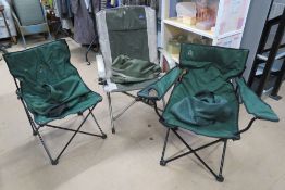 Three green canvas fishing or camping chairs.