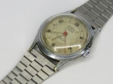 A Tourist Automatic wristwatch having silvered dial with red seconds hand.