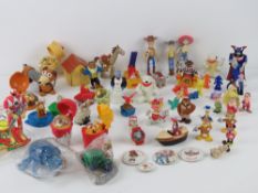 A quantity of assorted Disney, McDonald's, Burger King toys including Coca Cola bears,