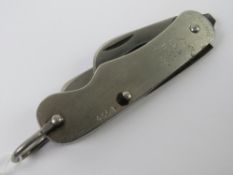A British army knife being blade and bottle/can opener, having broad arrow upon and dated 1953.