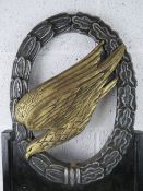 A re-enactor's sign and WWII German para trooper symbol upon, a/f, standing approx 100cm high.