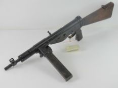 A deactivated Sten MK V 9mm sub machine gun with moving cocking handle,