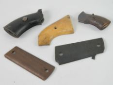 Two pairs of pistol grips together with three assorted single pistol grips.