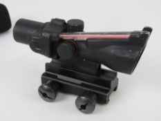 A Trijicon ACOG 2x20 optical sight, with self-illuminating red triangular reticule.