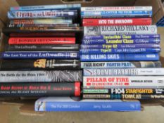 A box containing a quantity of assorted military and aviation themed books.