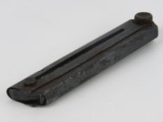 An inert German Luger magazine, with wooden base.