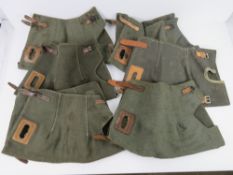 A quantity of six MG53 canvas breach covers with leather straps.