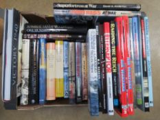 A box containing a quantity of assorted military and aviation themed books.