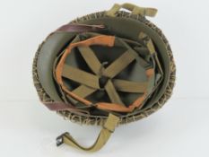 A WWII US Army McCord helmet having heat stamp that dates it to 1945,