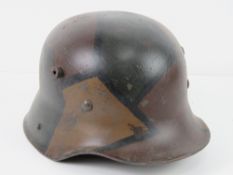 A reproduction WWII German helmet with liner and chin strap.