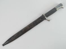 A WWII German K98 parade bayonet by Alcoso Solingen, with scabbard, blade measuring 25cm in length.