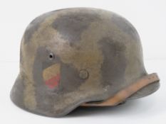 A reproduction WWII German helmet with liner and chin strap.