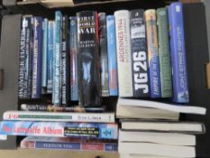 A box containing a quantity of assorted military and aviation themed books.