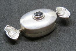 A HM silver pill pot in the form of a sweet in wrapper having red stoen to top, hallmarked 925, 5.