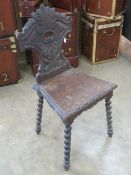 A stained oak single hall chair in Carol