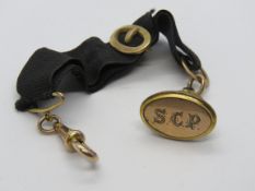 A Georgian gentlemans fob on waistcoat hanger, gilt metal fittings, fob engraved SCP.
