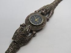 An unusual silver and marcasite encrusted ladies watch in the form of two articulated leopards,