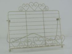 A contemporary white metal book stand ha