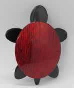 An overlaid plastic brooch in the style