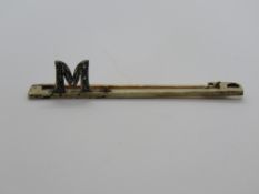 A 15ct 18ct PT brooch having M design se