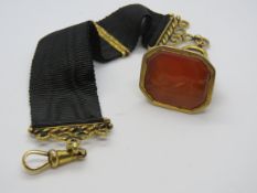A Georgian gentlemans carnelian seal on waistcoat hanger, carnelian a/f having cared hunting dog,