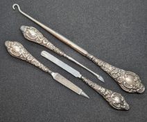 A set of three HM silver handled manicure tools together with a similar HM silver handles button