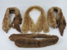 Four fur collars, two having heads upon.