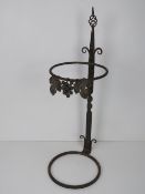A metal planter stand decorated with vin