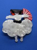 An overlaid plastic brooch in the style