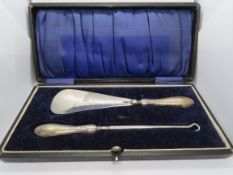A HM silver button hook and shoe horn in fitted box.