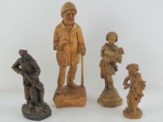 Four carved wooden figurines, 14-31cm hi