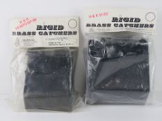 Two as new rigid brass catchers, in orig