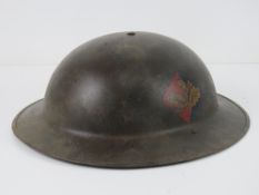 A reproduction WWII British helmet havin