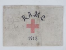 A WWI British R.A.M.C arm band dated 1915, in frame.