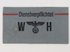 A WWII German Dienstverpflichtet arm band, in frame.