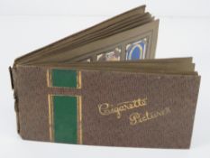 A cigarette card album containing a quantity of cards for regiments and planes,